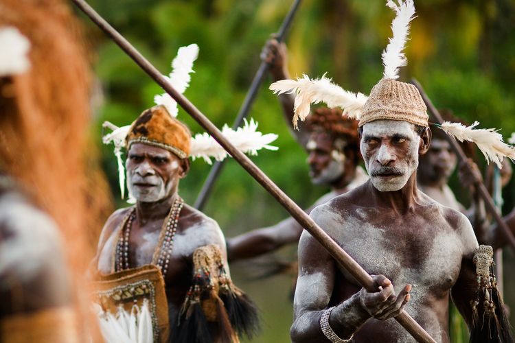 PAPUA (IRIAN JAYA), ASMAT PROVINCE, INDONESIA : JANUARY 18: Asmat headhunters display traditional and national tribal customs, dresses, and weapons on January 18, 2009 in Papua (Irian Jaya), Asmat Province, Indonesia.