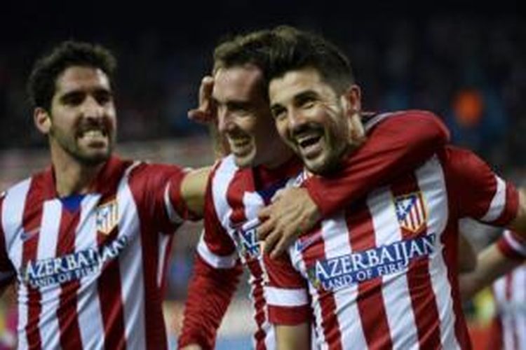 Striker Atletico Madrid, David Villa (kanan), bersama Diego Godin (tengah) dan Raul Garcia (kiri) merayakan gol ke gawang Sevilla pada laga Liga BBVA di Stadion Vicente Calderon, Madrid, Minggu (19/1/2014).