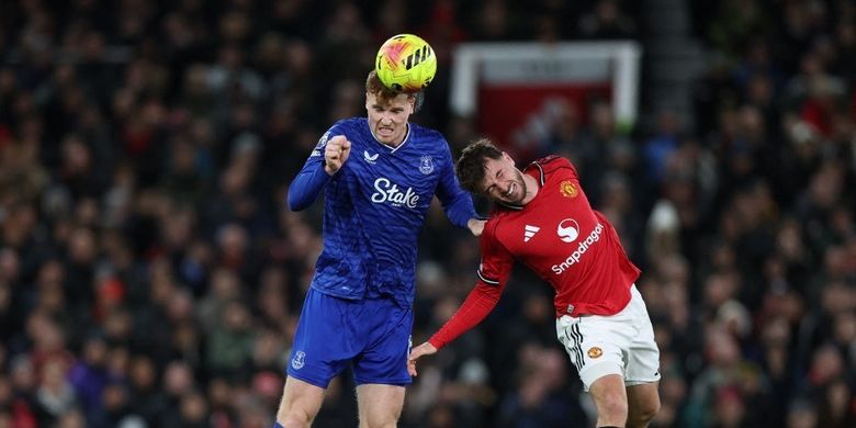 Jake O'Brien (kiri) berduel bola udara dengan Mason Mount (kanan) dalam pertandingan sepak bola Liga Inggris antara Manchester United vs Everton di Old Trafford di Manchester, barat laut Inggris, pada 24 November 2025. (Foto oleh Darren Staples / AFP)
