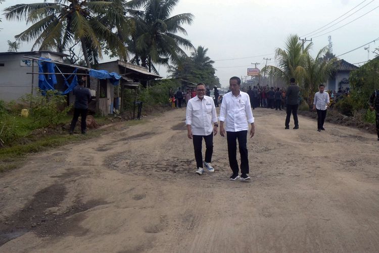 Presiden Joko Widodo (kiri) didampingi Menteri Perdagangan Zulkifli Hasan (kanan) meninjau jalan rusak di Kampung Rama Nirwana, Seputih Raman, Lampung Tengah, Lampung, Jumat (5/5/2023). Presiden Jokowi mengucurkan dana Rp 800 miliar untuk memperbaiki jalan rusak di Provinsi Lampung.
