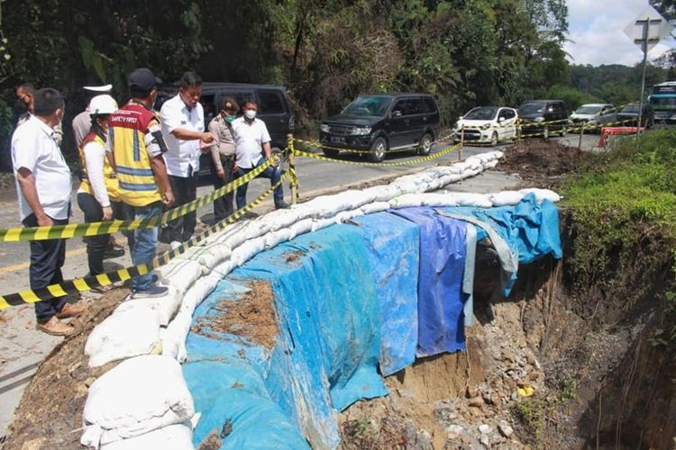 Bupati Simalungun Radiapoh Hasiholan Sinaga meninjau jalan longsor penghubung Pematangsiantar-Parapat di Nagori Parmonangan Kecamatan Dolok Panribuan Kabupaten Simalungun, Sumut, Selasa (19/4/2022).