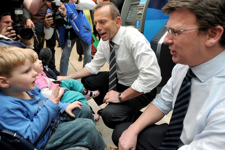 Alan Tudge (kanan) bersama pemimpin Partai Liberal Tony Abbott (kiri) berbicara dengan seorang anak di mal perbelanjaan, saat berkampanye di Melbourne, 19 Juli 2010.
