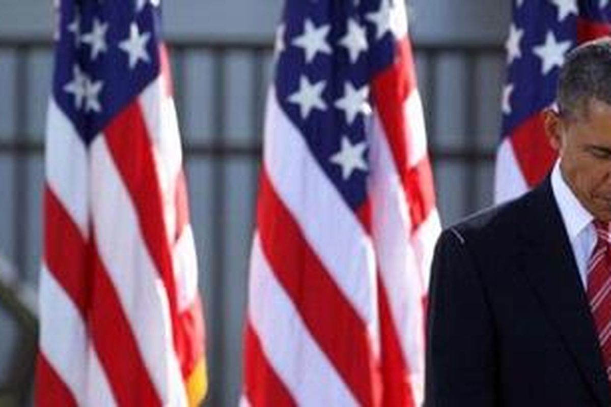 Remembering the fallen: President Barack Obama pauses during a ceremony today at the Pentagon  