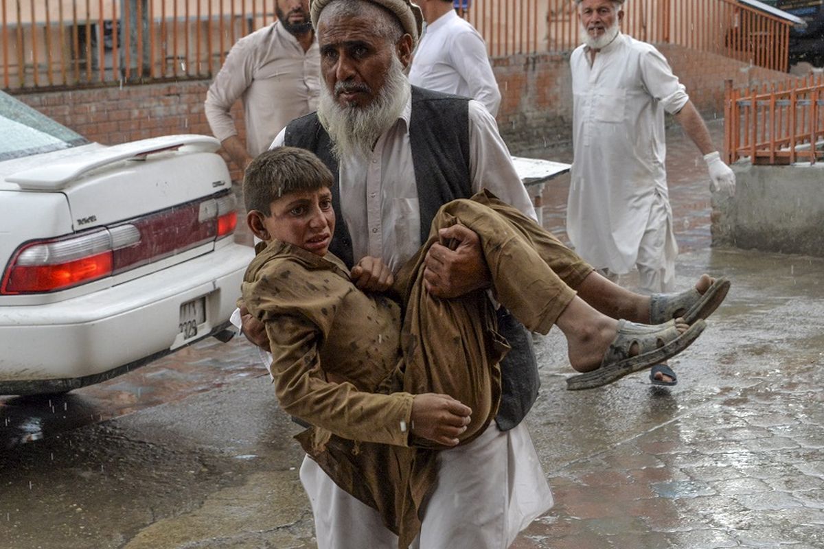 Warga menggotong seorang remaja yang terluka akibat ledakan di sebuah masjid di distrik Haska Mina, sekitar 50 kilometer dari Jalalabad, ibu kota provinsi Nangarhar, pada Jumat (18/10/2019).