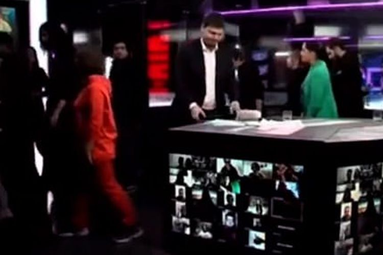 Staf yang bekerja untuk acara berita TV independen Rusia berjalan keluar dari lokasi syuting selama siaran terakhir mereka, setelah mereka dipaksa berhenti menampilkan liputan perang Ukraina.
