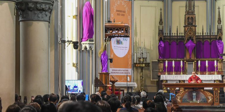 Catholics perform Good Friday prayer service at the Cathedral in the Indonesian capital of Jakarta on Friday, April 15, 2022. 