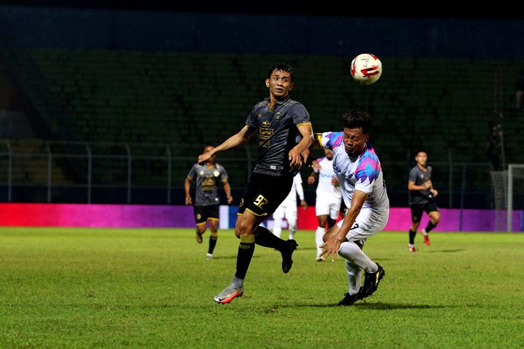 Pemain Arema FC, Dave Mustaine berebut bola dengan kapten RANS Cilegon FC Hamka Hamzah saat uji coba yang berakhir dengan skor 6-2 di Stadion Kanjuruhan Kabupaten Malang, Jawa Timur, Minggu (6/6/2021) malam.