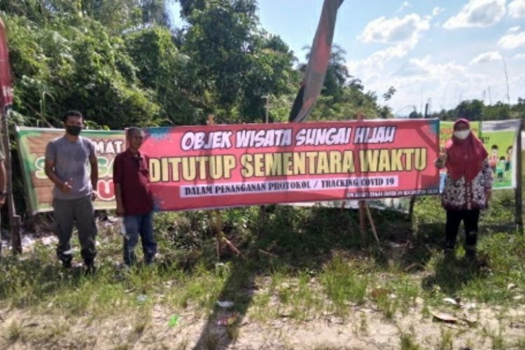 Pihak pengelola memasang spanduk penutupan objek wisata Sungai Hijau di Kota Bangkinang, Kabupaten Kampar, Riau, pasca dua kali dikunjungi seorang pasien positif Covid-19, Minggu (7/6/2020).