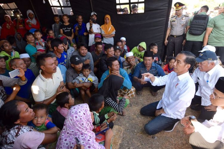 Presiden Joko Widodo berbincang dengan korban gempa di pusat pengungsian Desa Madayin, Kecamatan Sambelia, Kabupaten Lombok Timur, NTB, Senin (30/7/2018).