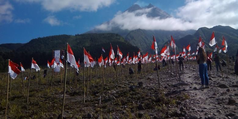 Raising 1000 red and white flags when celebration of Indonesian Independence Day at Kaliadem, Cangkringan, Yogyakarta, Indonesia with view of Merapi Mountain on Sunday, August 17, 2014.