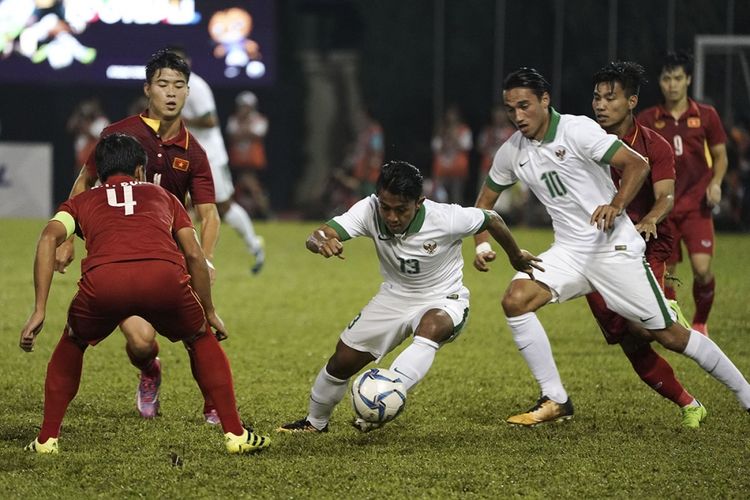 Pemain Timnas Indonesia U-22 Febri Haryadi (tengah) berusaha melewati pemain Timnas Vietnam U-22 Bui Tien Dung (kiri) dalam babak penyisihan grup B SEA Games XXIX Kuala Lumpur di Stadion Majlis Perbandaran Selayang, Malaysia, Selasa (22/8/2017). Bermain dengan 10 orang setelah Hanif Sjahbandi diusir wasit pada menit ke-63, Indonesia menahan imbang Vietnam dengan skor 0-0.