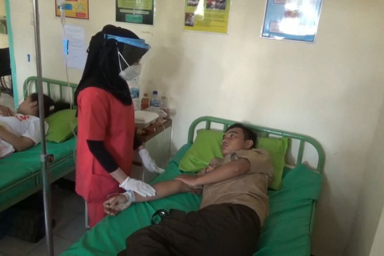 Petugas Puskesmas Banjar Rejo memriksa perkembangan kesehatan siswa SMKN 1 Rejotangan Tulungagung yang diduga akibat keracunan makanan, Minggu (10/20/2021).