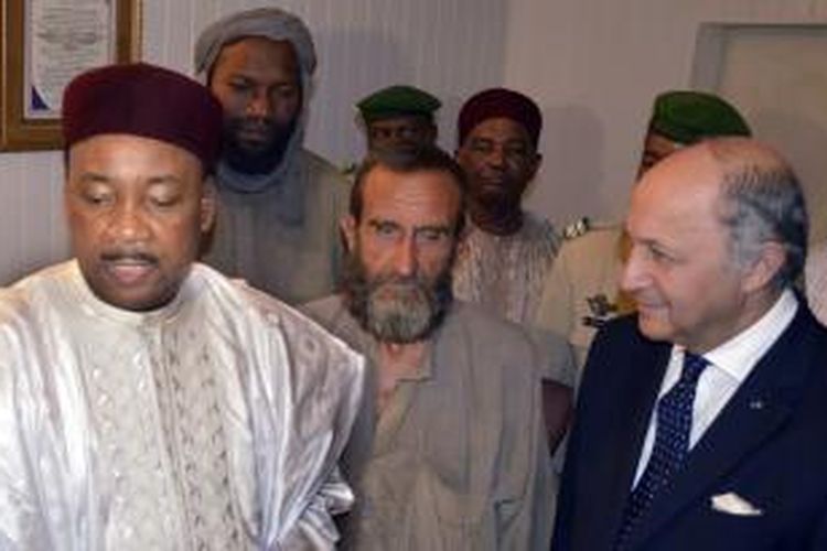 Presiden Niger Mahamadou Issofou (kiri) dan Menlu Perancis Laurent Fabius (kanan) menyambut dua dari empat sandera Perancis Thierry Dol (kedua dari kiri) dan Daniel Larribe (tengah) yang dibebaskan setelah tiga tahun disekap kelompok Al-Qaeda Wilayah Maghribi.