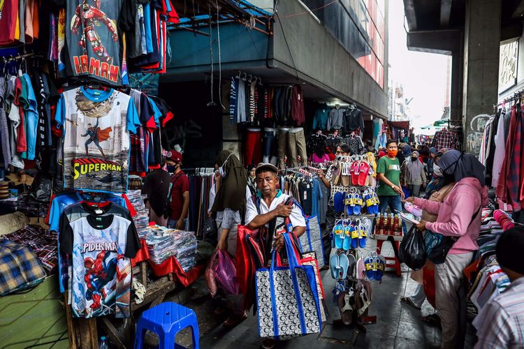 Warga saat berbelanja di tengah pembatasan sosial berskala besar (PSBB) di Pasar Tanah Abang, Jakarta Pusat, Senin (18/5/2020). Pedagang kembali meramaikan pasar Tanah Abang, saat Pemerintah Provinsi DKI Jakarta kembali memperpanjang penutupan sementara Pasar Tanah Abang hingga 22 Mei 2020 untuk mengurangi kerumunan orang di ruang publik guna mencegah penyebaran COVID-19.