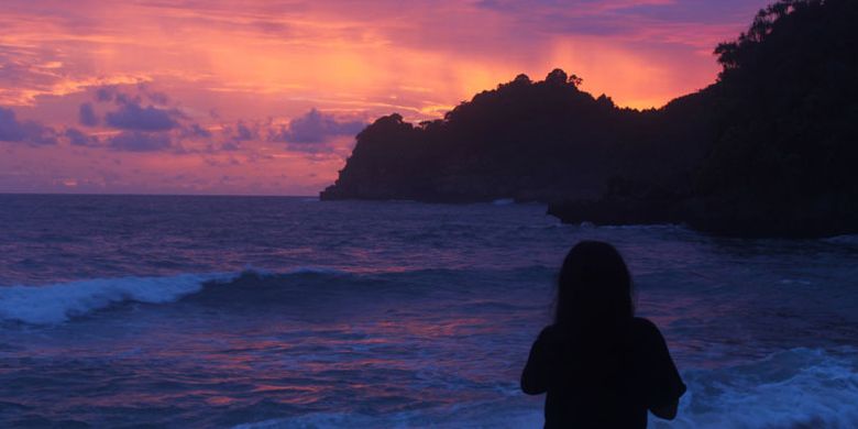 Seorang wisatawan saat menikmati senja di Pantai Selok, Sabtu (30/12/2017). Pantai yang memiliki ombak tinggi itu berada di dalam kawasan hutan lindung Kondang Merak, Kecamatan Bantur, Kabupaten Malang bagian selatan.