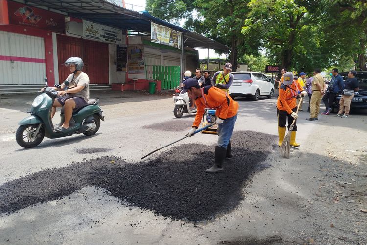 Petugas melakukan penambalan jalan di Jalan Kepiting Kota Banyuwangi.