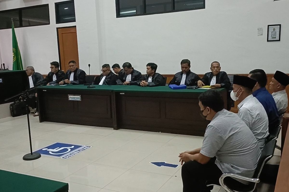 Kades Kohod Arsin (menggunakan peci bermasker) saat duduk dikursi terdakwa untuk menjalani sidang perdana kasus korupsi pagar laut di perairan Kabupaten Tangerang di Pengadilan Tipikor Serang. Selasa (30/9/2025).