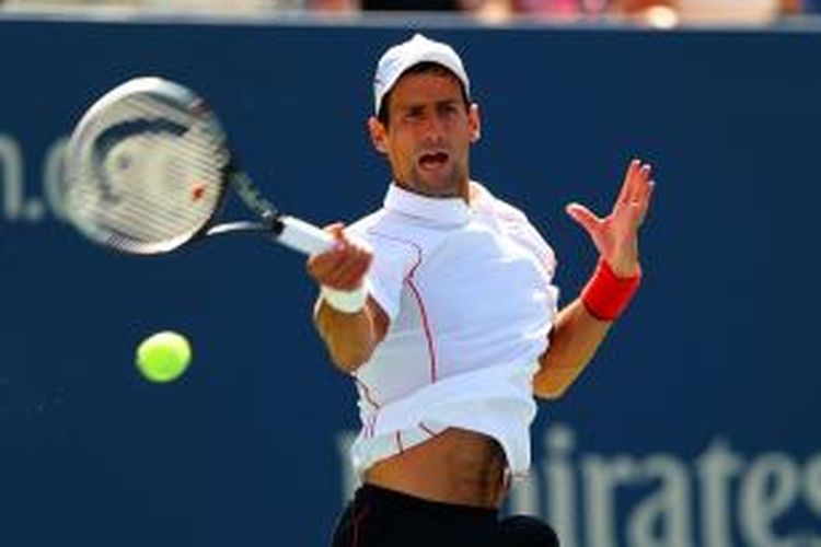 Petenis Serbia, Novak Djokovic melakukan pukulan forehand ke arah Stanislas Wawrinka dari Swiss, pada laga semifinal US Open yang berlangsung di USTA Billie Jean King National Tennis Center, New York, Sabtu (7/9/2013).