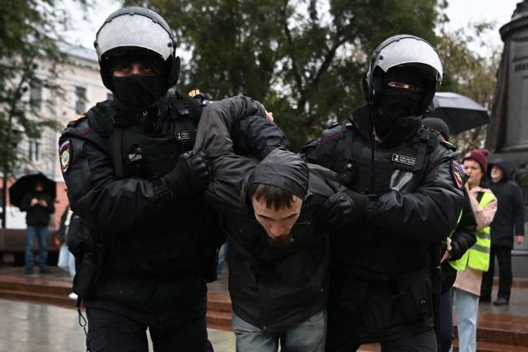 Petugas kepolisian menahan seorang pria di Moskwa, Rusia, pada Sabtu (24/9/2022) dalam aksi demo memprotes mobilisasi parsial yang diumumkan oleh Presiden Rusia Vladimir Putin. 