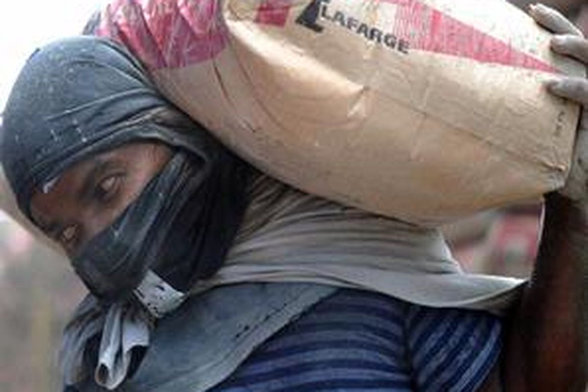 A labour off loads sacks of cement at a construction site in down town Kuala Lumpur on June 15, 2010. Malaysia  last week unveiled a 69-billion-dollar plan intended to spur growth and attract much-needed foreign investment. The country is aiming to become a high-income economy by 2020 rather than continuing to rely on its low-cost structure to make it attractive.
