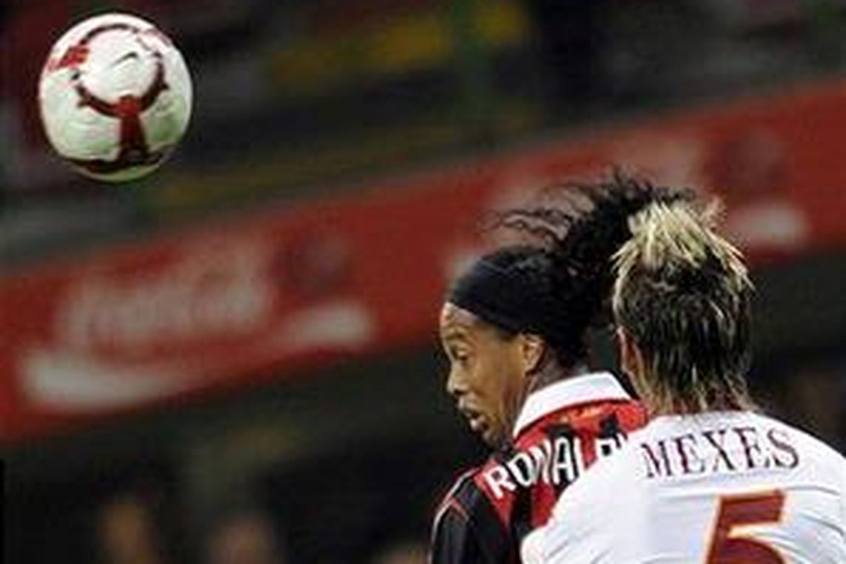 Bek AS Roma, Philippe Mexes, mengawal gelandang AC Milan, Ronaldinho, saat keduanya bertempur dalam lanjutan Serie-A, di San Siro, Minggu (18/10). Sempat unggul 1-0, Roma malah menutup laga dengan kekalahan 1-2.