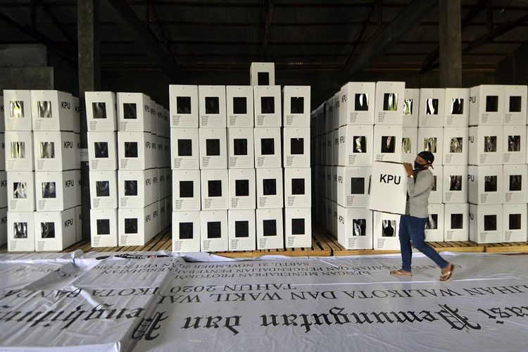 A staffer is carrying a ballot box in the General Elections Commission warehouse in Lampung on Sumatra island. Indonesia is set to hold simultaneous regional elections in 270 regions across the country. 