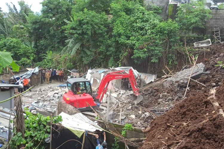 Alat berat excavator tengah mengali tanah dalam proses pencarian dua orang korban yang tertimbun tanah longsor di Jalan Kendedes, Ubung, Kecamatan Denpasar Utara, Kota Denpasar, Provinsi Bali, pada Senin (20/1/2025) pagi. KOMPAS.com/ Yohanes Valdi Seriang Ginta