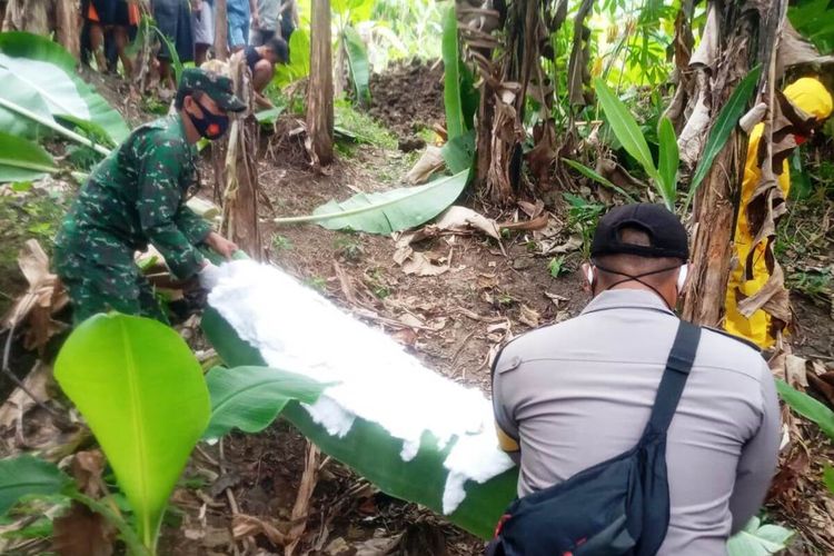 Anggota TNI/Polri mengevakuasi jenazah seorang petani di Kabupaten Cianjur, Jawa Barat, yang ditemukan tewas terbakar di gubuknya, Minggu (19/7/2020)