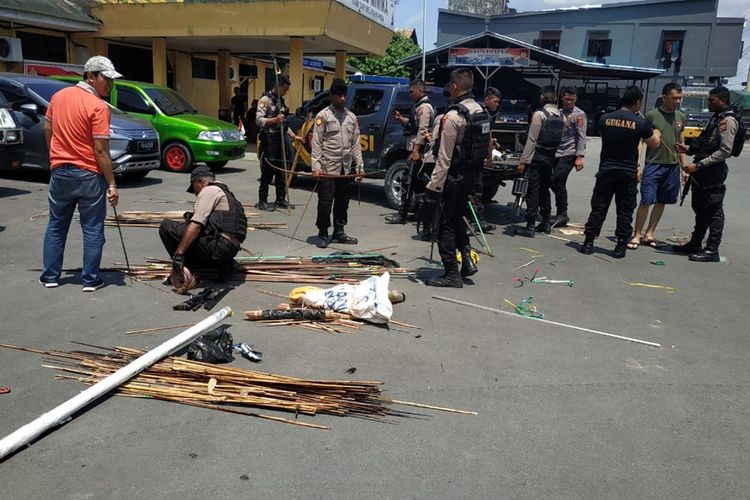 Polisi mengumpulkan anak panah hasil razia di Kwamki Narama, Mimika, Papua, Selasa (22/10/2019)
