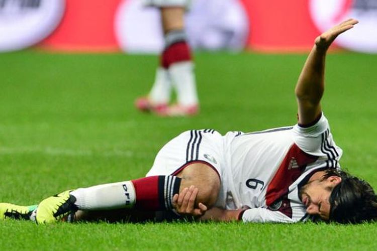 Gelandang Jerman, Sami Khedira, tampak kesakitan karena cedera lutut ketika negaranya melawan Italia dalam pertandingan uji coba di Milan, Jumat (15/11/2013).