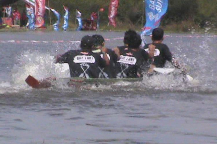 Salah satu tim tampak bersemangat mengayuh perahu mereka untuk menjadi pemenang dalam lomba bidar mini tradisional di Desa Burai Ogan Ilir