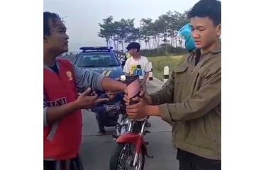 Tangkapan layar video menampilkan polisi berpakaian preman tengah memberi shock therapy ke pemuda yang akan membunyikan mercon di pintu keluar tol Duwet, Pekalongan, Jumat (23/4/2021) pagi.