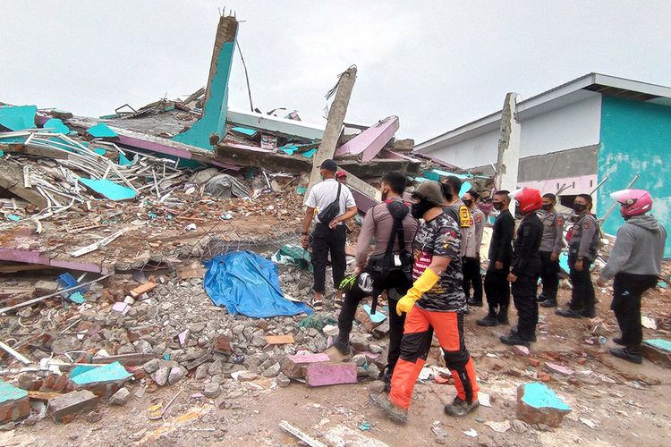 Petugas mengamati bangunan RS Mitra Manakarra yang roboh pascagempa bumi, di Mamuju, Sulawesi Barat, Jumat (15/1/2021). Petugas BPBD Sulawesi Barat masih mendata jumlah kerusakan dan korban akibat gempa bumi berkekuatan magnitudo 6,2 tersebut.