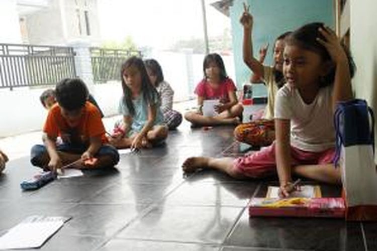 Sekelompok anak belajar bersama di pekarangan rumah karena sekolah diliburkan hingga batas waktu yang tidak ditentukan terkait kabut asap, di kawasan Kinibalu Pekanbaru, Rabu (16/9/2015).