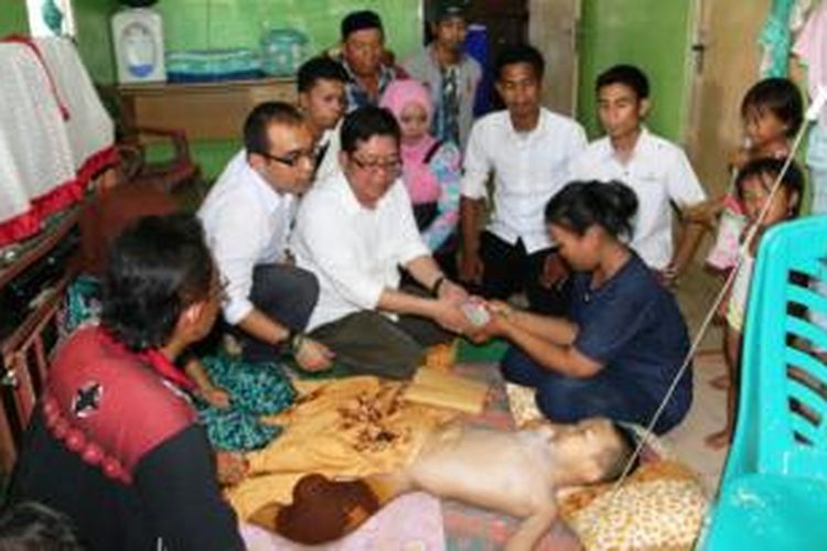 Relawan Jokowi Center Aceh di Meulaboh, menyalurkan bantuan biaya untuk pengobatan Kholid Ferdiansyah (8), Minggu (26/4/2015).