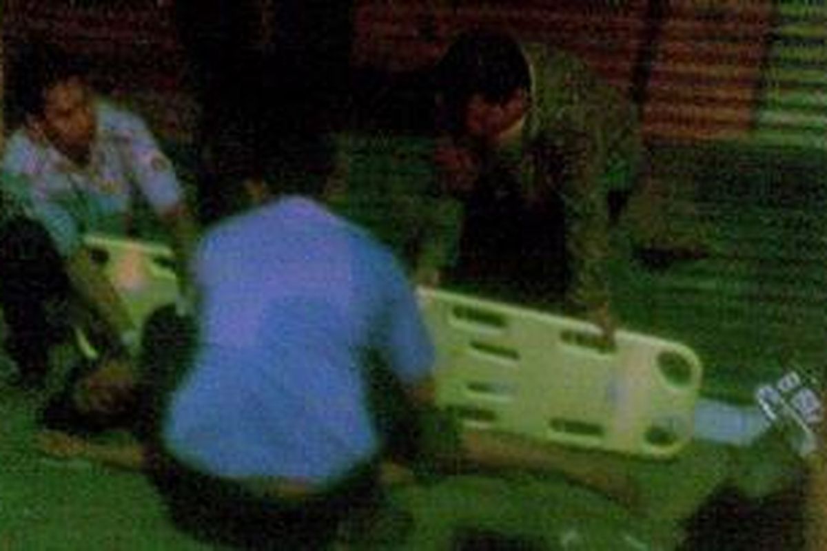 Petugas medis dibantu polisi mengevakuasi korban kecelakaan lalu lintas di Jalan Dewi Sartika, Cililitan, Jakarta Timur, Sabtu (19/3/2011) dini hari.
