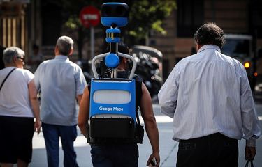 epa07672697 A man (C) carries one of Googles Street View Trekker backpack to capture photographs of the city, around San Sebastian, Spain, 25 June 2019.  EPA-EFE/JAVIER ETXEZARRETA