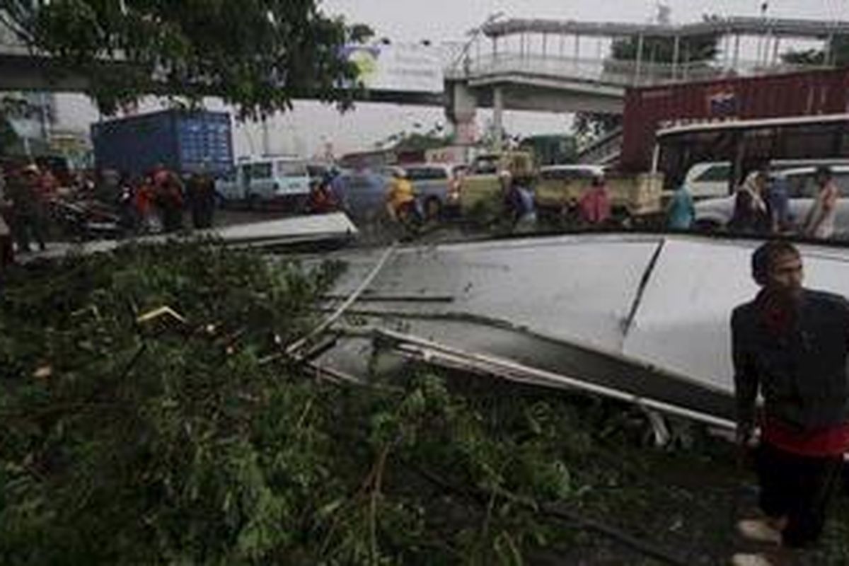 Kanopi jembatan penyeberangan orang di akses halte bus Transjakarta Jembatan Lima di depan mal Season City, Jakarta, jatuh ke jalan akibat angin kencang berikut hujan yang melanda Kamis (5/1/2012). Di sejumlah ruas jalan, pohon-pohon, baliho reklame, dan tiang listrik tumbang dan menimbulkan kemacetan.