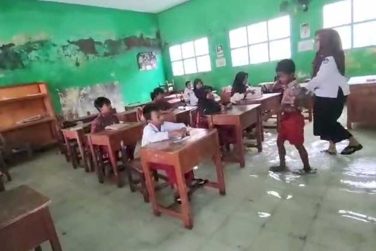 Siswa siswi SDN 3 Ambulu Desa Ambulu Kecamatan Losari Kabupaten Cirebon Jawa Barat melakukan aktivitas belajar mengajar di tengah banjir rob pada Kamis (9/1/2025) siang.