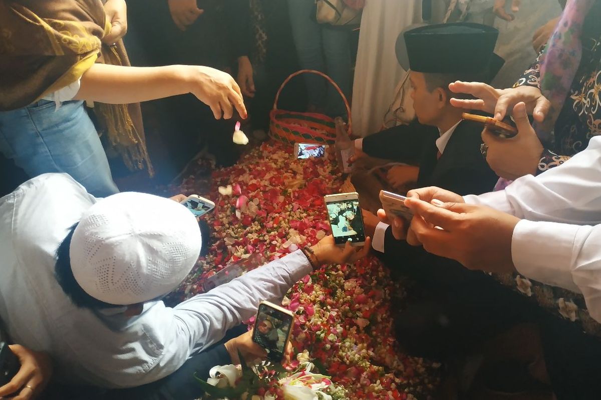 Warga melayat sekaligus berswafoto dengan makam BJ Habibie di TMP Kalibata usai upacara pemakaman, Kamis (12/9/2019).