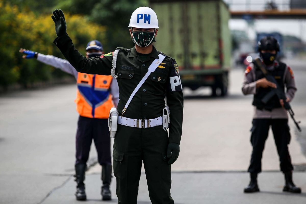 Petugas gabungan memeriksa kendaraan di gerbang tol Cikupa, Kabupaten Tangerang, Banten, Kamis (28/5/2020). Selama operasi pemeriksaan kepada masyarakat dari luar Jabodetabek yang ingin masuk ke Jakarta diharuskan menunjukkan SIKM, berdasarkan peraturan gubernur (Pergub) Nomor 47 Tahun 2020 yang mewajibkan membawa SIKM sebagai syarat memasuki wilayah Jakarta.