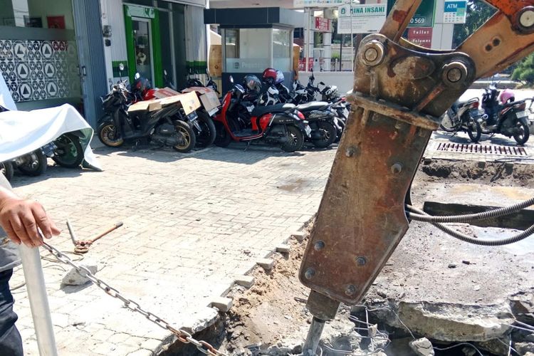 Proses pembongkaran penyambung jalan masuk (PJM) tanpa izin atau yang menghambat aliran air di sekitar Jalan Wolter Monginsidi dan Kaligawe Semarang. 