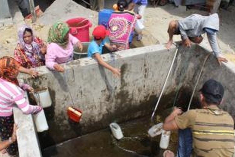 Warga Desa Lainungen, Kabupaten Sidrap, Sulawesi Selatan, menyerbu bak penampungan air yang hanya berisi air keruh demi kebutuhan sehari-hari. Selama dua bulan terakhir krisis air bersih melanda desa itu.