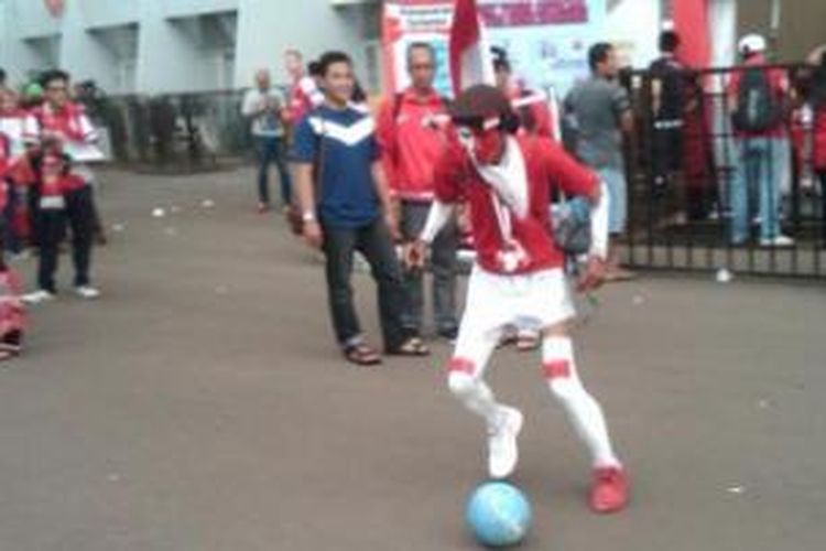 Pendukung Indonesia asal Cempaka Putih, Kurniawan, melakukan aksi menggiring bola di Stadion Utama Grlora Bung Karno. Aksi ini ia lakukan demi mendukung Indonesia melawan Arsenal, Minggu (14/6/2013) ini.