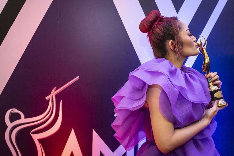 Penyanyi dangdut Siti Badriah berpose dengan memegang piala penghargaan pada Malam Anugerah Musik Indonesia (AMI) 2019 di Jakarta, Rabu (27/11/2019). Siti Badriah berhasil meraih penghargaan AMI 2019 untuk kategori artis solo pria/wanita rock/instrumen dangdut kontemporer terbaik.