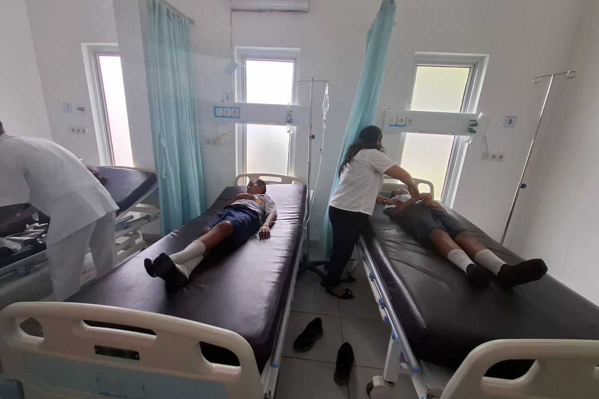 Tim medis saat mengevakuasi siswa SMP Negeri 1 Laguboti ke rumah sakit karena diduga keracunan MBG, Rabu (15/10/2025)     