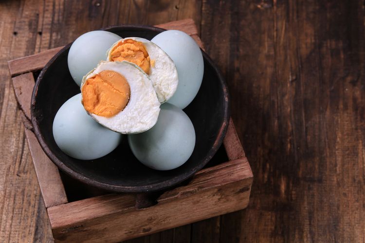 Ilustrasi telur asin di dalam mangkuk. 