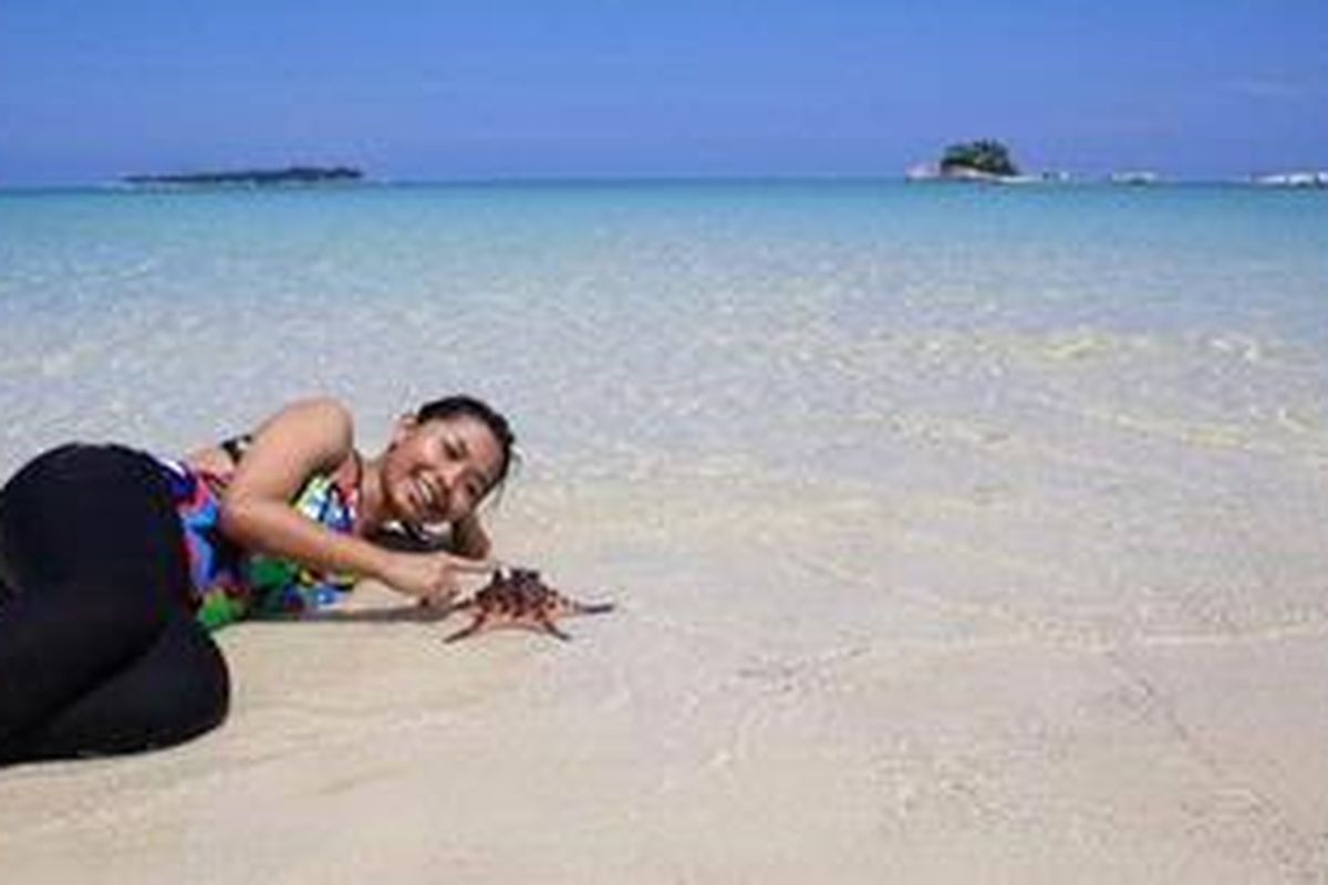 Wisatawan di Pulau Pasir, Belitung. Pulau ini terkenal dengan biota bintang laut. 