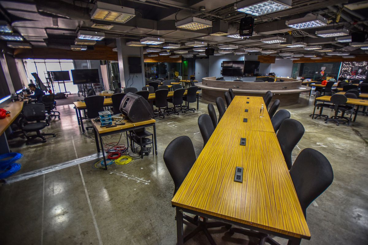 An employee (L) of news online portal Rappler works inside their office in Pasig City, suburban Manila on June 29, 2022. (Photo by MARIA SALVADOR TAN / AFP)