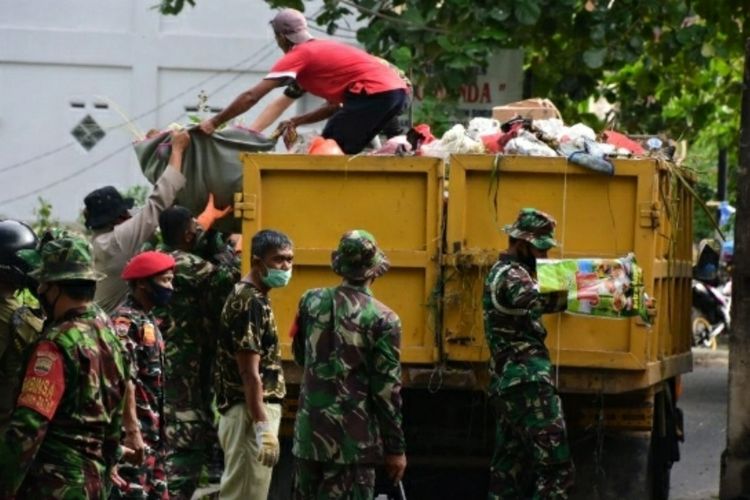 Petugas gabungan TNI dan Polri mengangkut sampah yang menumpuk disejumlah pasar di Kota Pekanbaru, Riau, Jumat (8/1/2021).